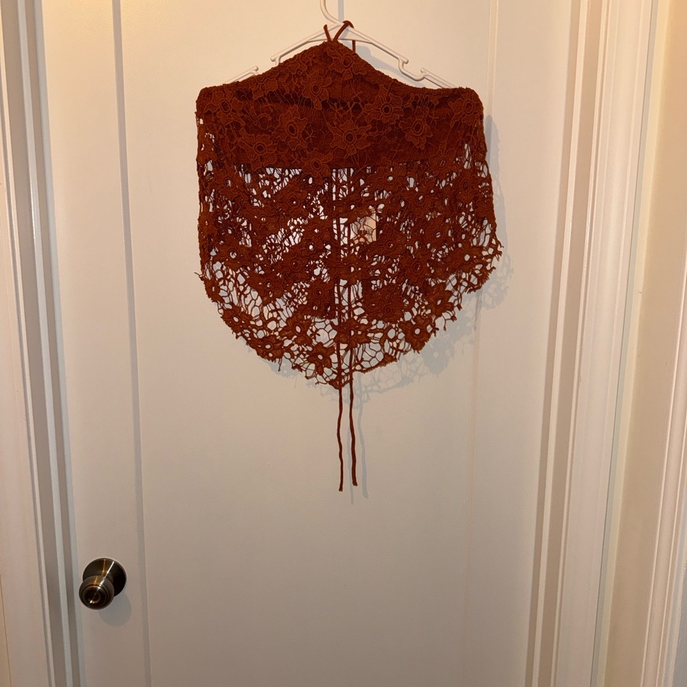 This is a Free People Seychelles lace halter top in a rust orange
